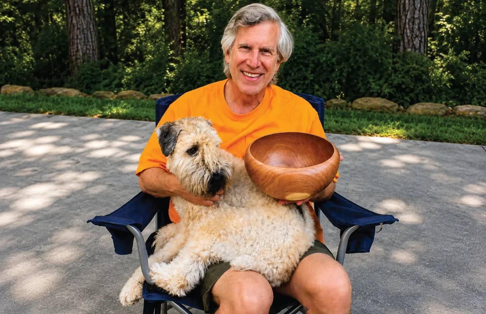 Russ Freed and Baxter the wheaten terrier with a hand-turned mesquite bowl